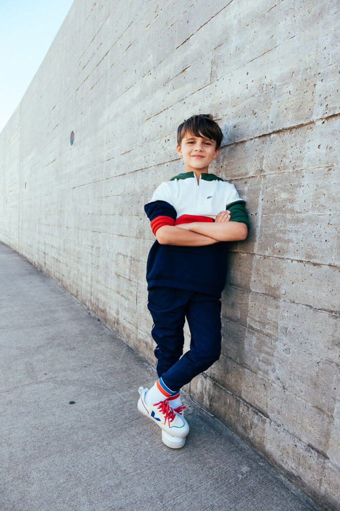 three children sitting on steps, smiling together, fun sibling photography
