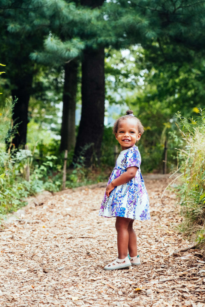 boy leaning against concrete wall, casual kids fashion photography