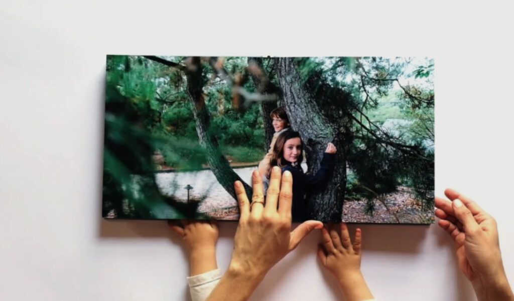 Mom and baby looking at family photo album together - displaying family photos in everyday life