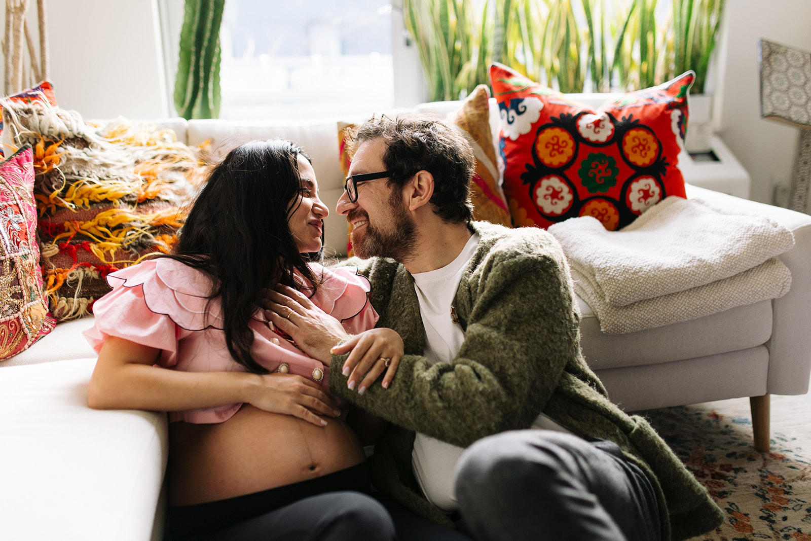 couple smiling at each other in their maternity session